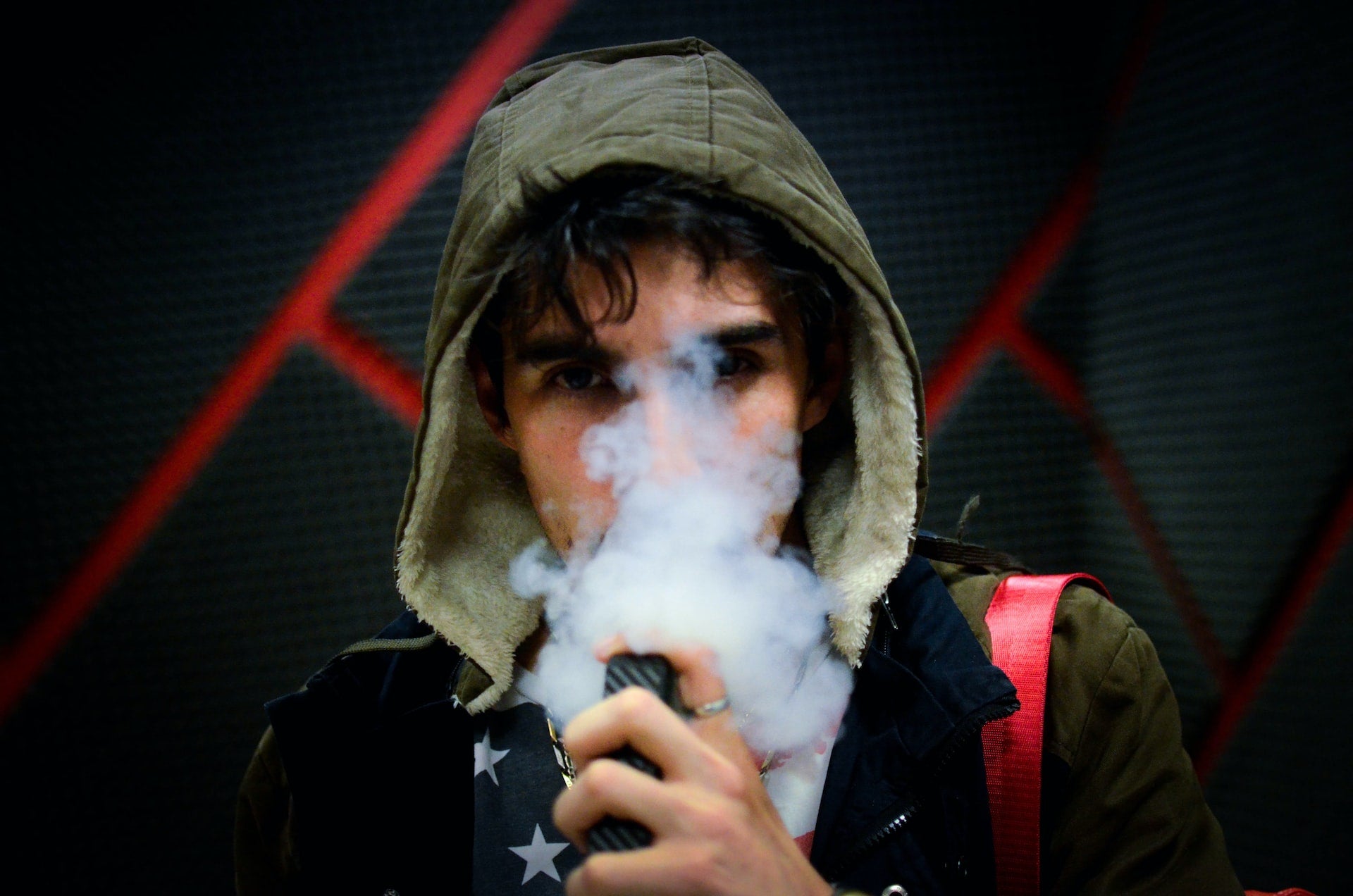 man wearing a hoodie and vaping